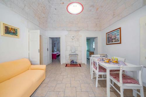a living room with a couch and a table at Salentina by Rentbeat in Ostuni
