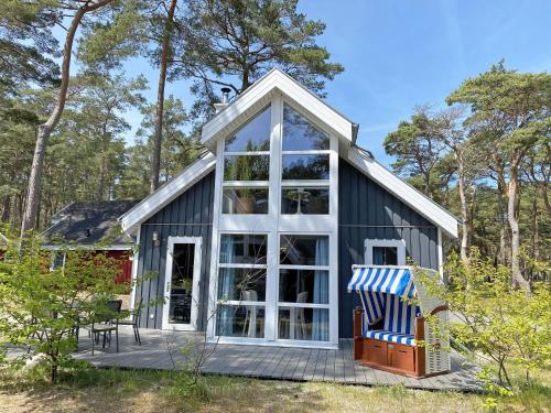 a tiny house with a large window at Ferienhaus Sandkörnchen - Strandpark - ca. 80m Strand in Baabe