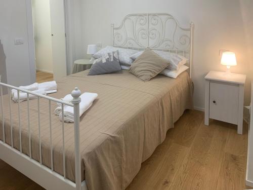 a bedroom with a large bed with a white headboard at CamiLa's house in Milan