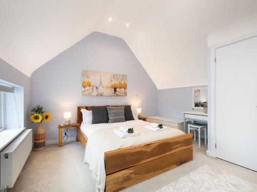 a bedroom with a large bed and a desk at Pass the Keys Central Marlow townhouse with private parking in Marlow