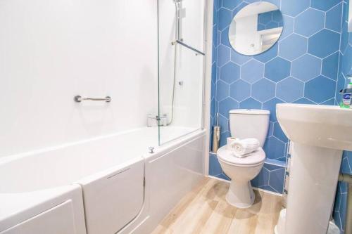 a bathroom with a toilet and a sink and a shower at Beachside Cottage - Camber Sands - Close to beach in Camber