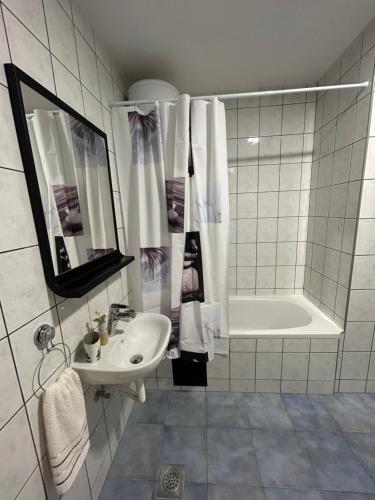 a bathroom with a sink and a bath tub at Apartman Milla in Ljubuški