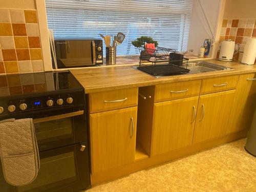 a kitchen with a sink and a stove top oven at Seaview in Lossiemouth