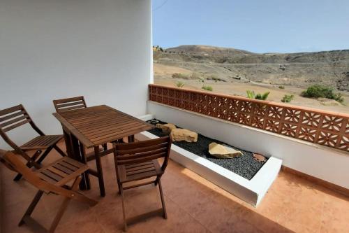 a balcony with a table and chairs and a view at Casagrande Sunset II - Fuerteventura - Costa Calma in Pájara