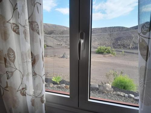 a window with a view of a desert view at Casagrande Sunset II - Fuerteventura - Costa Calma in Pájara