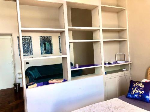 a white book shelf in a room with a bed at B&B Vista Mare in Naples
