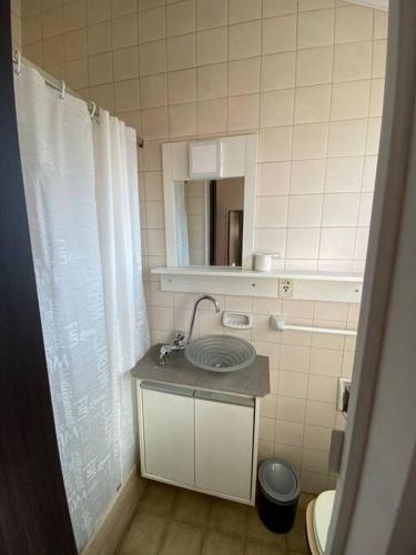 a bathroom with a sink and a mirror at Depto. excelente ubicación in Villa Marini
