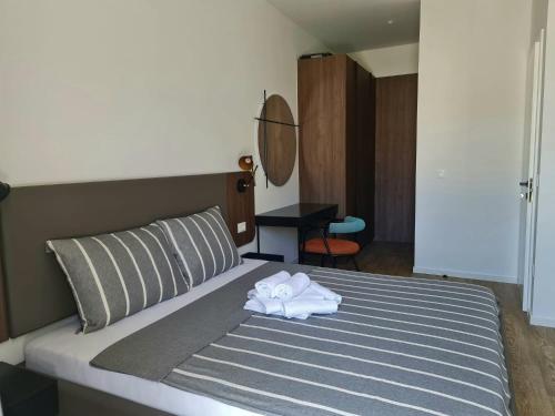 a bed with a pair of white towels on it at Apartman Nika Makarska in Makarska
