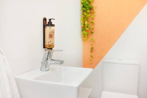 a bathroom with a sink with a soap dispenser on it at Villa Belafonte in Câmara de Lobos