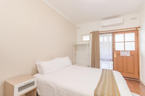 Ένα ή περισσότερα κρεβάτια σε δωμάτιο στο Warburton Lodge