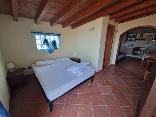 a bedroom with a white bed and a window at Monolocali in centro paese in Lampedusa