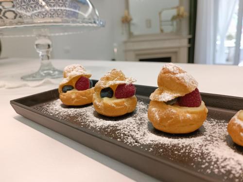 four pastries on a tray on a table at Vittorio Veneto Private SPA in Sulmona