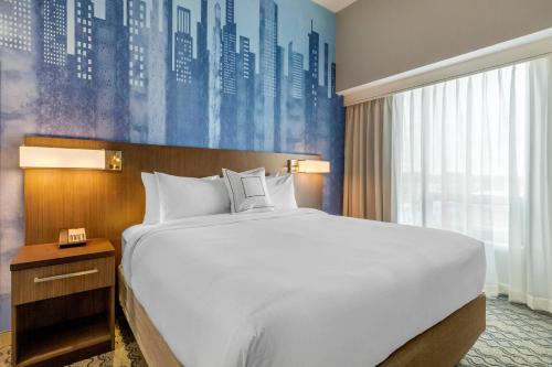 a bedroom with a large bed and a large window at Residence Inn Providence Downtown in Providence