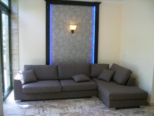 a couch in a living room with a window at Andreas House in Dassia