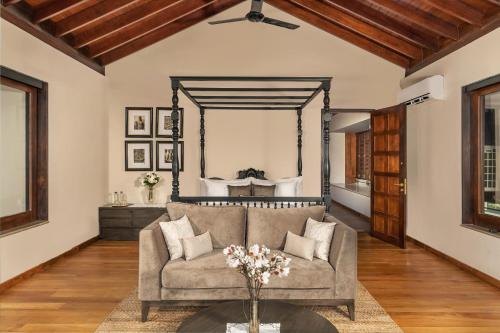 a living room with a couch and a mirror at The Alfred Digana by The One Group of Hotels in Digana