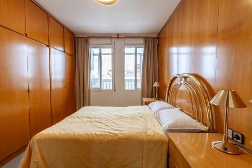 a bedroom with a large bed and a window at Sea view apartments in Malgrat de Mar