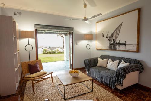 a living room with a couch and a table at Saxenburg Wine Farm in Kuilsrivier