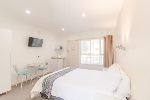 Ένα ή περισσότερα κρεβάτια σε δωμάτιο στο Warburton Lodge