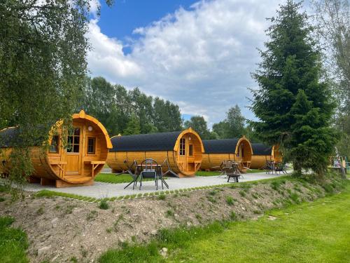 a group of wooden cabins in a park at Camping u Kukačků in Horní Planá