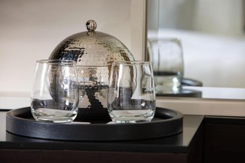 three glasses sitting on a black tray on a table at JW Marriott Essex House New York in New York