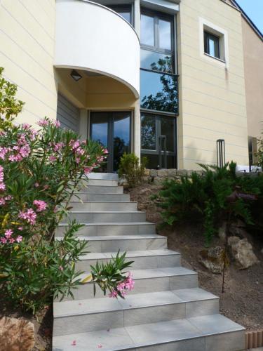 a stairway leading up to a house with flowers at La Désirade in Salles-la-Source