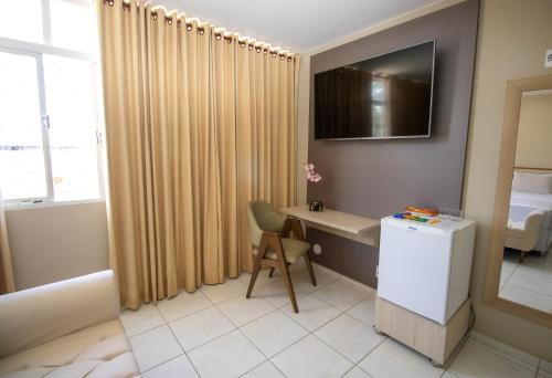 a room with a desk and a chair in a room at Alvimar Hotel in Sobradinho