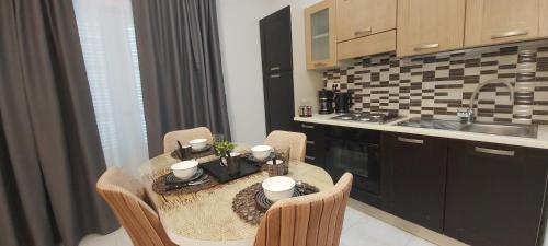 a kitchen with a table with chairs and a kitchen with a sink at Serenity Milatos in Milatos