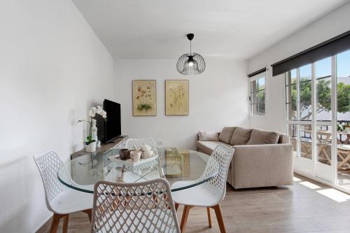a living room with a glass table and chairs at Apartamento Puerto Playa in Puerto del Rosario