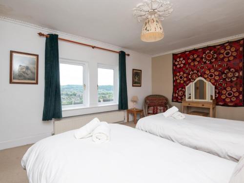 a bedroom with two white beds and a window at Pass the Keys Spacious family home with amazing views in Bath