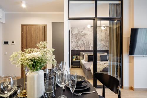 a dining room with a table with wine glasses at Muse - LoftAffair Spa Collection in Kraków