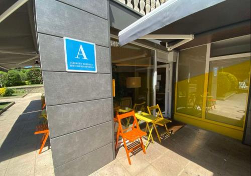 a sign on the side of a building with chairs at Blai Blai Hostel in Zarautz