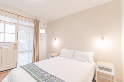 Ένα ή περισσότερα κρεβάτια σε δωμάτιο στο Warburton Lodge