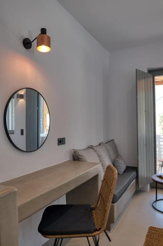 a living room with a mirror and a couch at Clementina Paros in Naousa