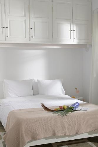 a bed with white cabinets and a bowl of fruit on it at CASA D'IRENE Mykonian residence in Mýkonos City