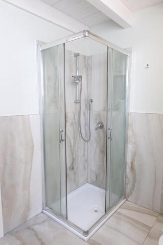 a shower with a glass enclosure in a bathroom at Loft2 via morosini centro Varese - Ixihome in Varese
