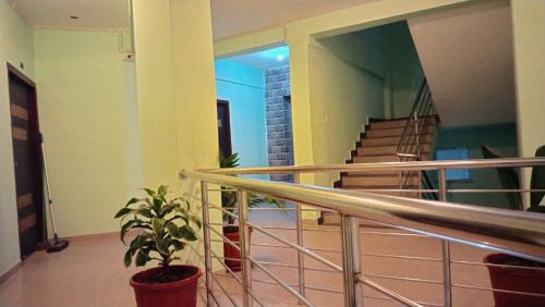 a room with a staircase and a potted plant at HOTEL PURI GREENS in Puri