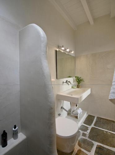 a bathroom with a white toilet and a sink at CASA D'IRENE Mykonian residence in Mýkonos City