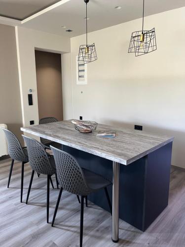 a dining room with a table and chairs at Grand Kourouta in Kourouta