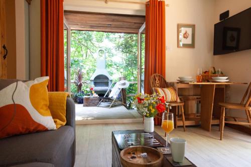 a living room with a couch and a table at Hayne Barn Estate - Luxury Lodges - with private hot-tubs - The studio-loft is without hot-tub in Hythe