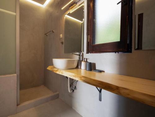 a bathroom with a sink and a mirror at Dohos Hotel in Karítsa