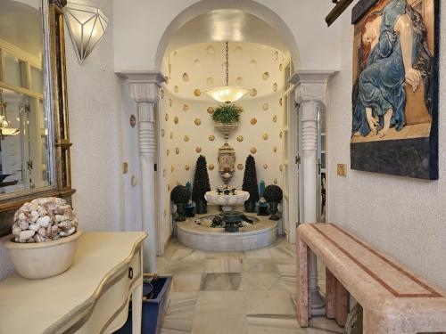 a hallway with a fountain in the middle of a building at Apartamento Las Terrazas in La Herradura