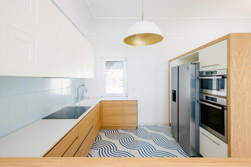 a kitchen with white cabinets and a zebra print floor at Acquachiara Seaside Luxury Villa in Amalfi Coast in Maiori