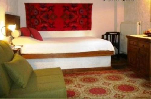 a bedroom with a bed with a red headboard at Agrampeli in Méga Khoríon