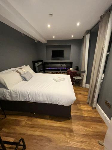 a bedroom with a bed and a television in it at Cosy Double Bed With Fire Place in Edinburgh
