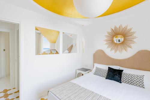 a bedroom with a bed and a yellow ceiling at Acquachiara Seaside Luxury Villa in Amalfi Coast in Maiori
