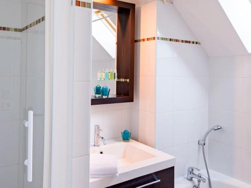 une salle de bain avec un lavabo et une baignoire dans l'établissement Cancale Port Family Stay, à Cancale