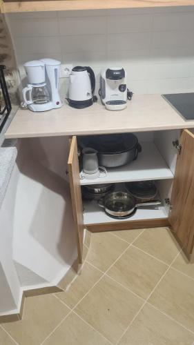 a shelf with pots and pans on it in a kitchen at Olympus in Olýmpoi