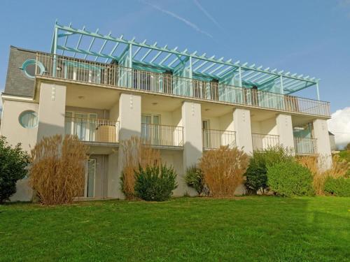 Un grand bâtiment blanc avec un balcon est disponible. dans l'établissement Apartment in Audierne near Trescadec Beach, à Audierne