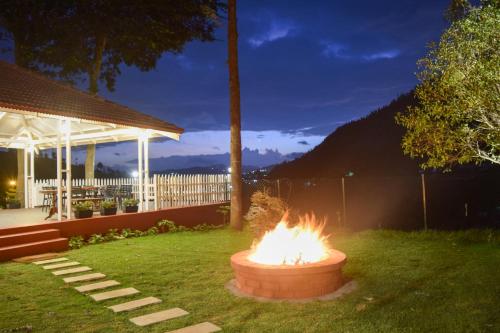 a fire pit in the middle of a yard at Ibex Resorts, Coonoor Leewood in Coonoor