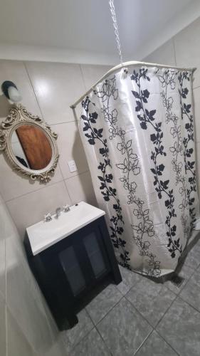 a bathroom with a sink and a mirror at Casa de 3 ambientes in Río Grande